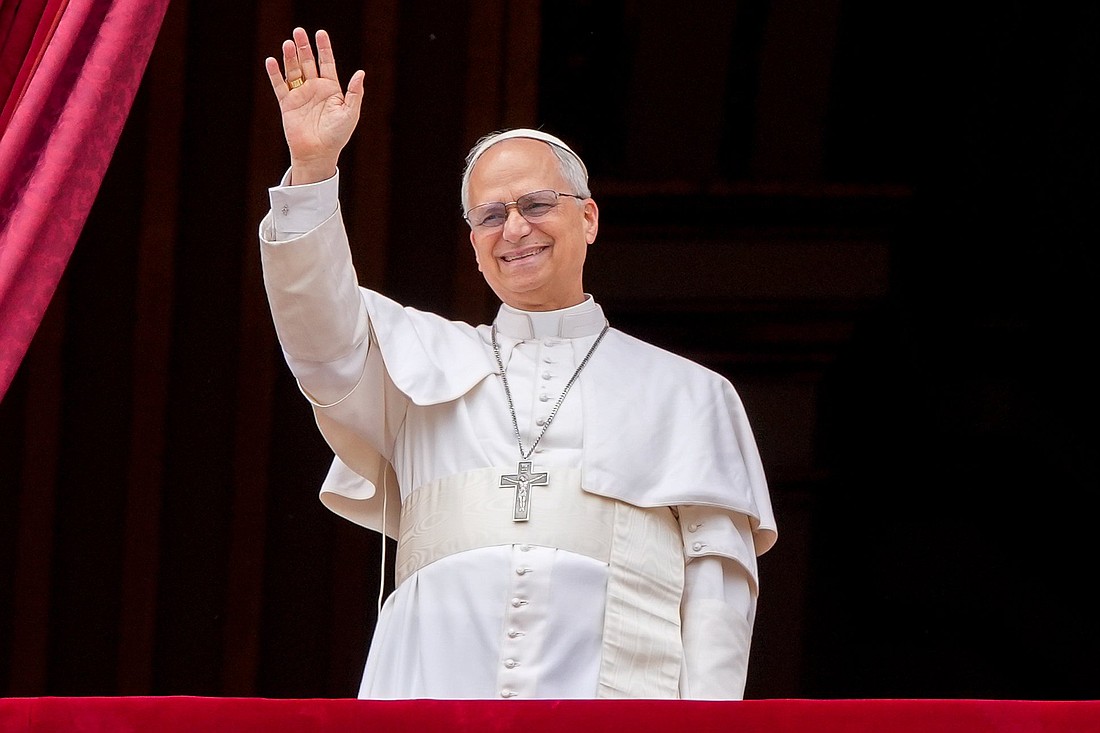 Pope Leo XIV waves to the crowd from the central balcony of St. Peter's Basilica at the Vatican as he leads, for the first time, the midday recitation of the "Regina Coeli" prayer May 11, 2025. (CNS photo/Lola Gomez)