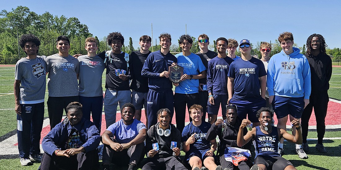 Lawrenceville's Notre Dame High School boys track & field team proudly displays its championship plaque after claiming the inaugural Colonial Valley Conference Meet title May 10 at Robbinsville High. The win came in coach Joe McLaughlin's last spring season as head coach. Courtesy photo