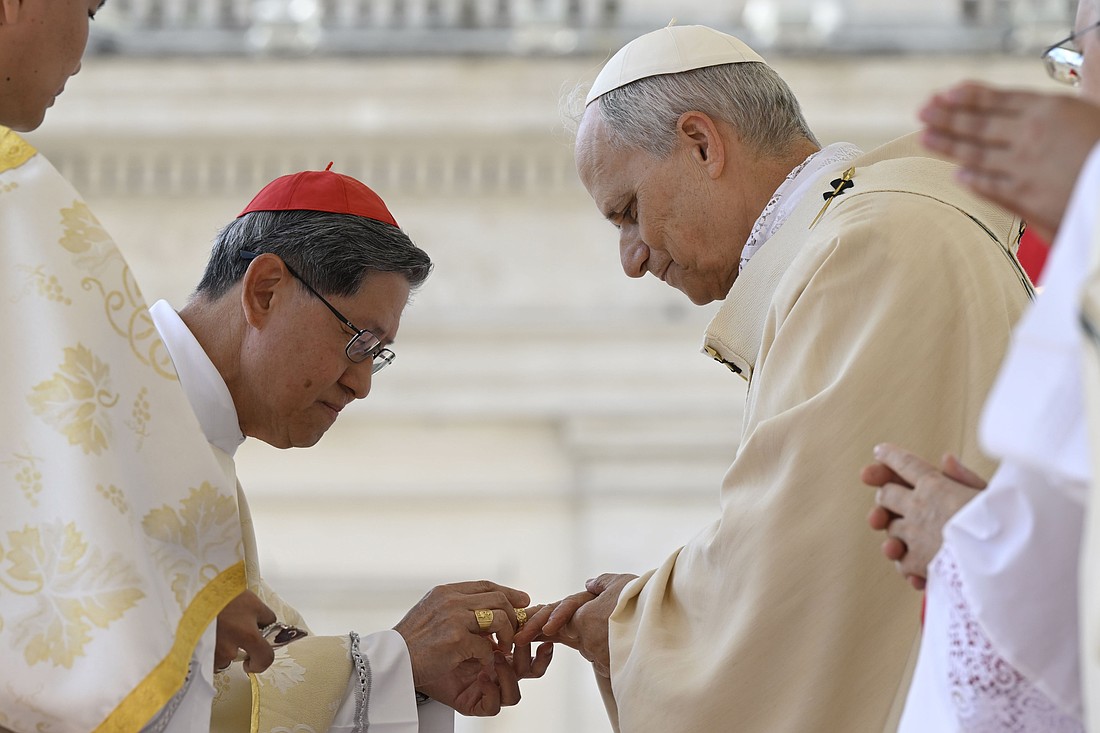 Pope Leo XIV receives the fisherman's ring, symbolizing his role as successor to St. Peter, from Filipino Cardinal Luis Antonio Tagle during the pope's installation Mass in St. Peter's Square May 18, 2025. (CNS photo/Kendall McLaren)