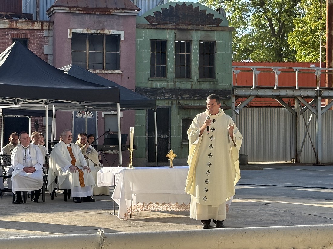 Photo Caption: Father Tom Lanza delivers the homily in the Batman Stunt Arena, where he challenged the youth to “see the world as God does.” Rose O'Connor photo