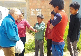 Sister Eileen Egan shares corn and beans from the her garden with those in need in 2020. The IHM Sisters have served in Peru since 1965. Facebook photo