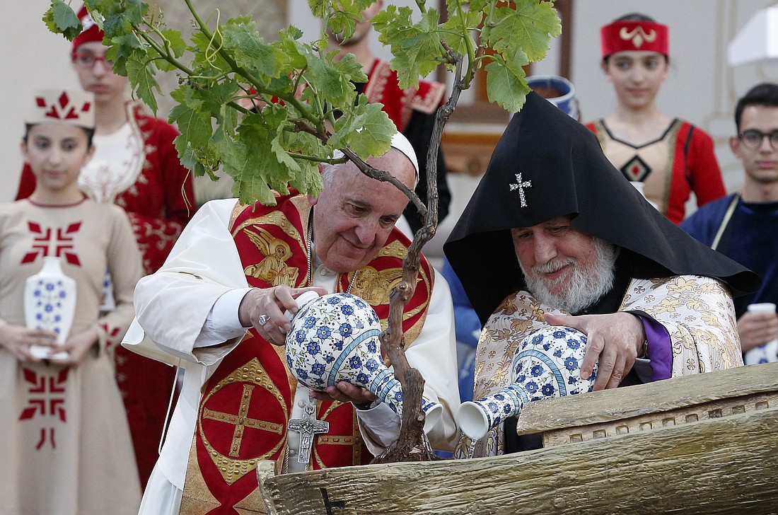 Pope Francis and Catholicos Karekin II, patriarch of the Armenian Apostolic Church, pour water on a tree in a model of Noah's Ark during an ecumenical meeting and prayer for peace in Republic Square in Yerevan, Armenia, June 25, 2016. (CNS photo/Paul Haring)