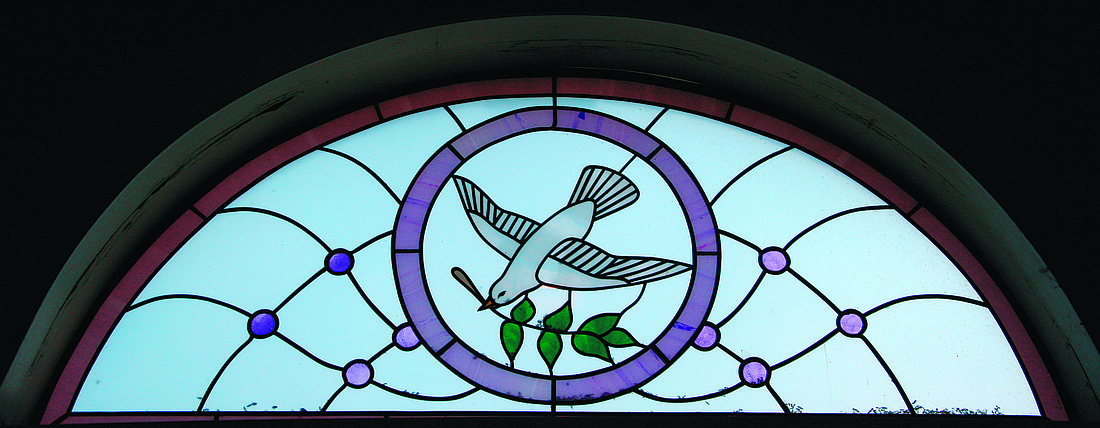 This stained glass image in St. Monica Church, Jackson, reflects the message of how the Holy Spirit is needed to guide the Church. File photo