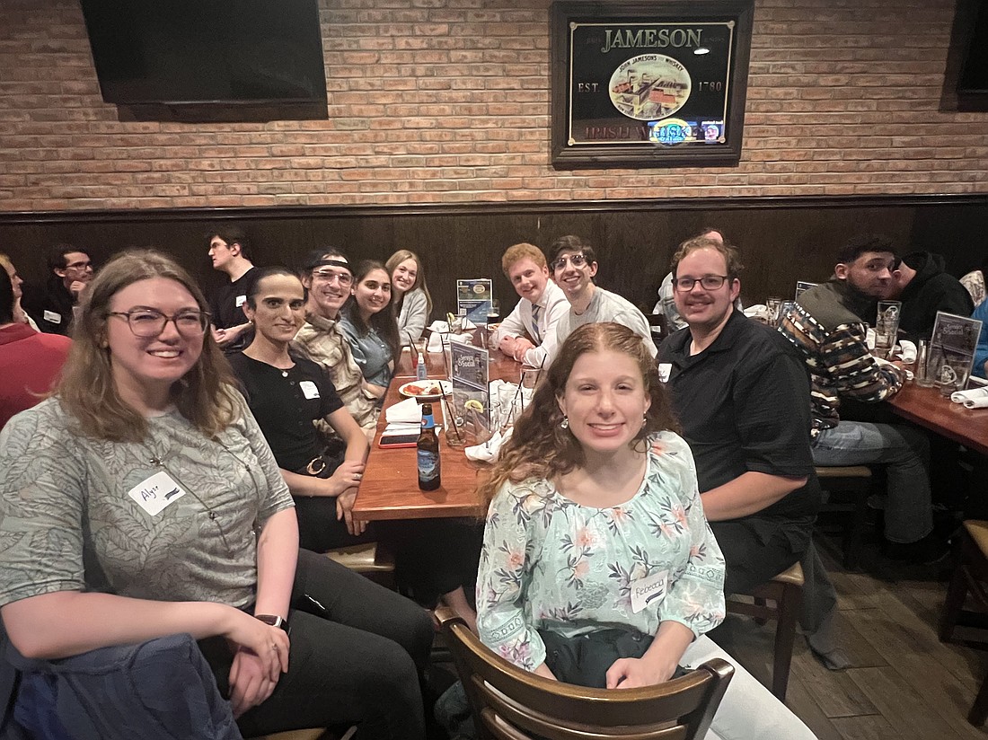Young adults pose for a photo during the May 22 Theology on Tap gathering in Burlington County.