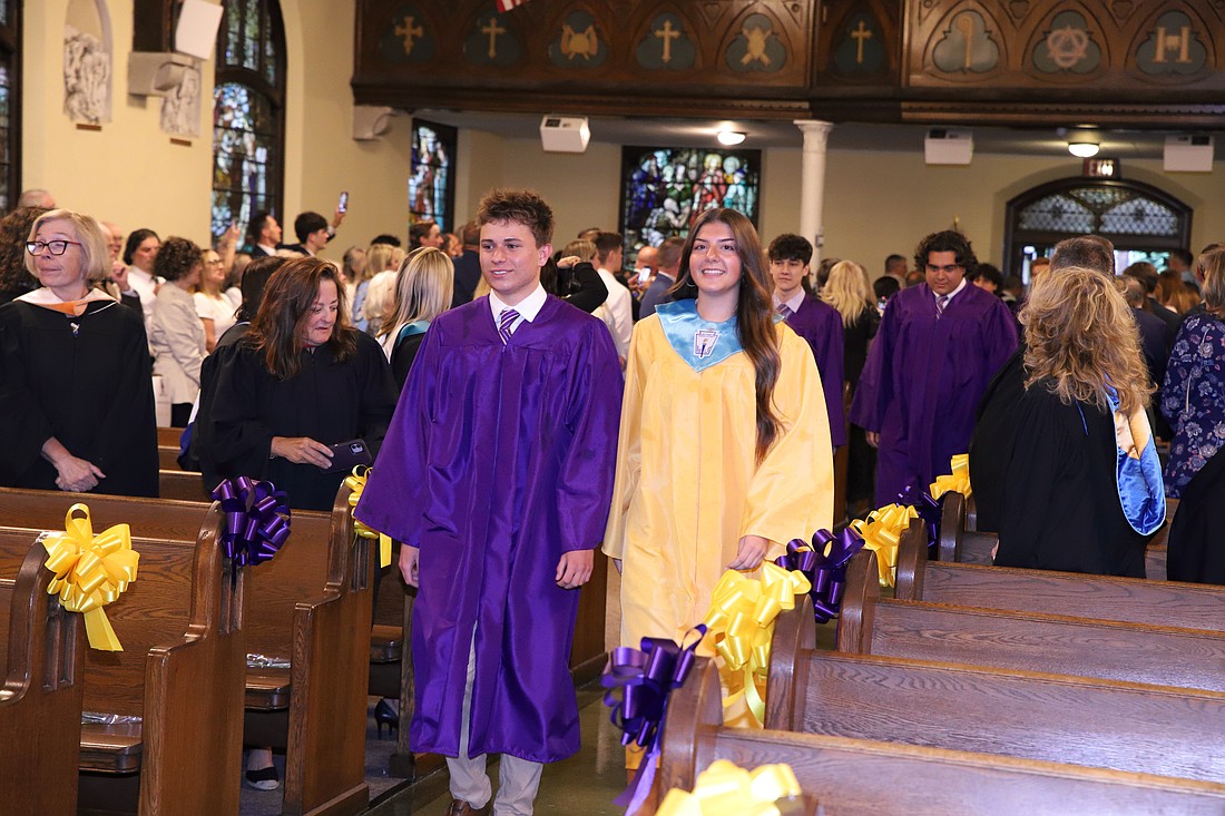 Students process into St. Rose Church at the start of the Baccalaureate Mass.