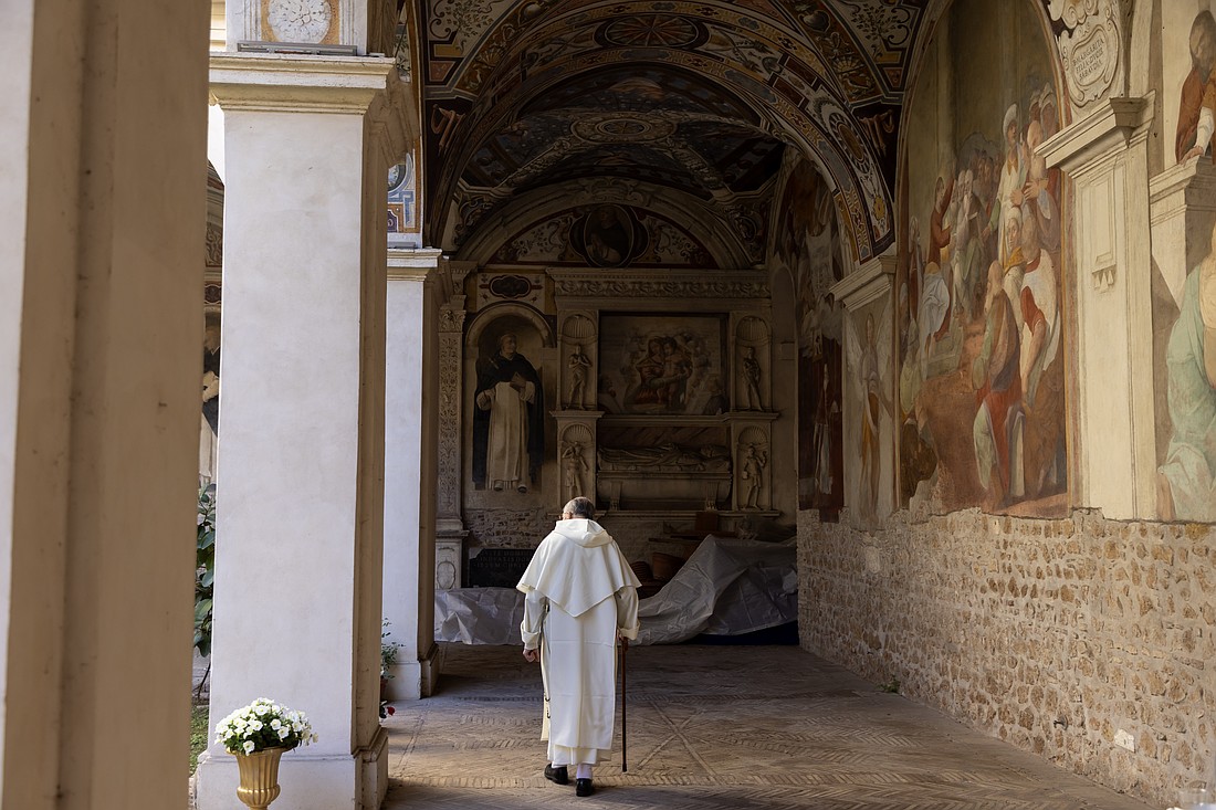 A Dominican friar walks in the frescoed cloister of his convent next to the Basilica of Santa Maria Sopra Minerva in Rome April 18, 2024. The friars have opened the cloister to visitors, although few tourists and pilgrims know it exists. (CNS photo/Pablo Esparza)