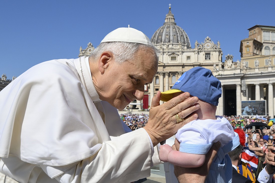 Pope Leo XIV greets a child as he rides in the popemobile before celebrating Mass in St. Peter’s Square at the Vatican June 1, 2025, as part of the Jubilee of Families, Children, Grandparents and the Elderly. (CNS photo/Vatican Media)