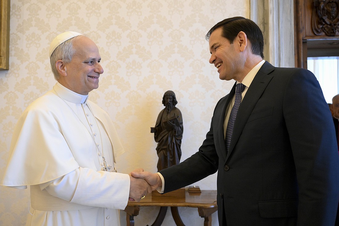 Pope Leo XIV shakes hands with Secretary of State Marco Rubio in the library of the Apostolic Palace at the Vatican May 19, 2025. (CNS photo/Vatican Media)
