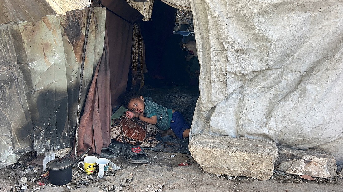 A Palestinian child displaced by the Israeli military offensive lies inside the tent he took shelter in with his family May 25, 2025, in Gaza City, Gaza Strip. (OSV News photo/Reuters)