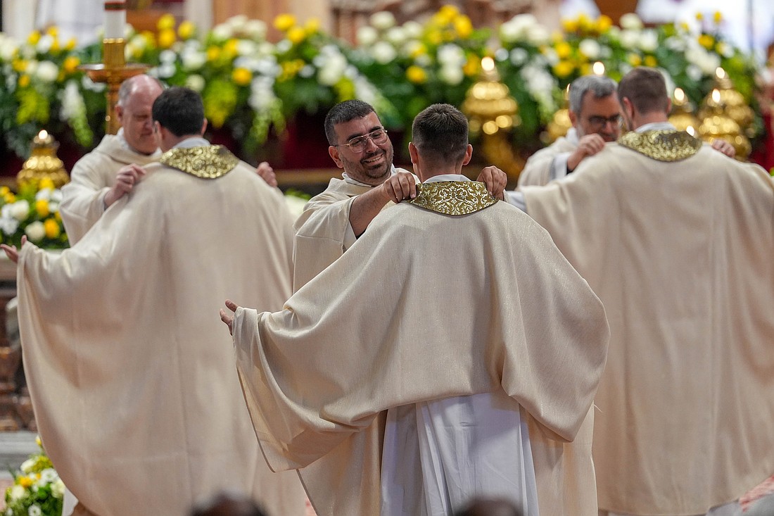 Priests help newly ordained priests vest during their ordination Mass celebrated by Pope Leo XIV in St. Peter’s Basilica at the Vatican May 31, 2025. (CNS photo/Lola Gomez)