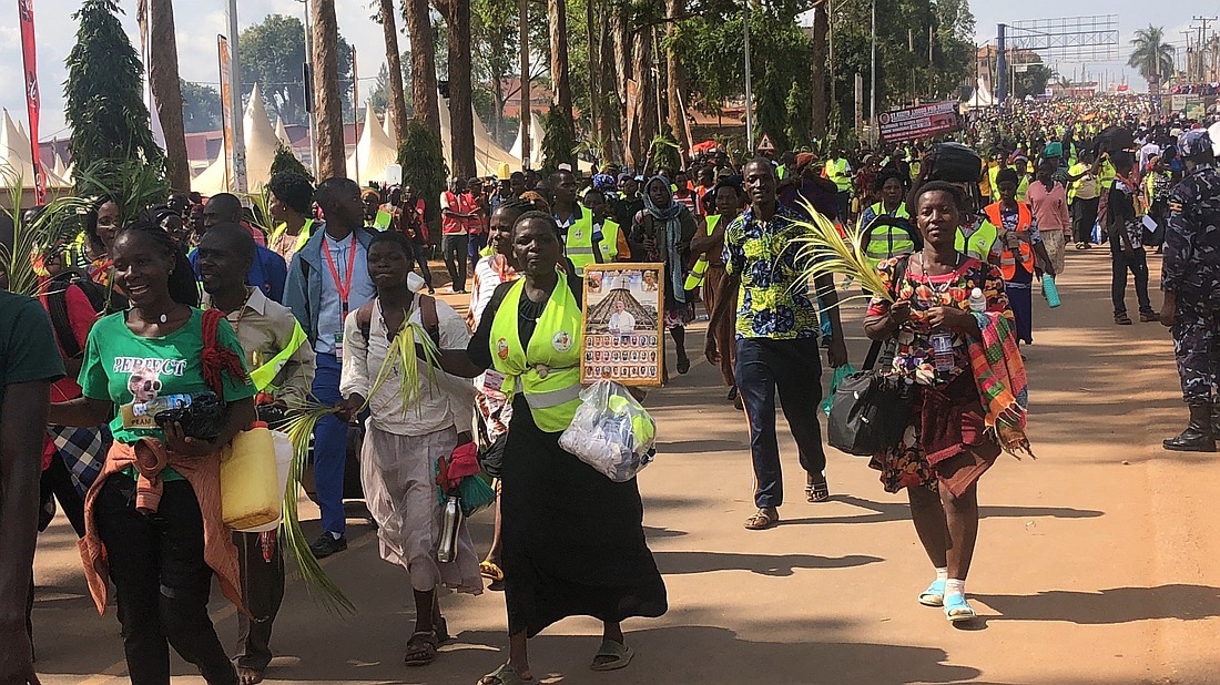 Pilgrims arrive at Namugongo Catholic Shrine in Uganda May 31, 2025, some carrying palm leaves and others holding images of martyrs and Pope Leo XIV, marking the climax of their spiritual journey. (OSV News photo/Tonny Onyulo)