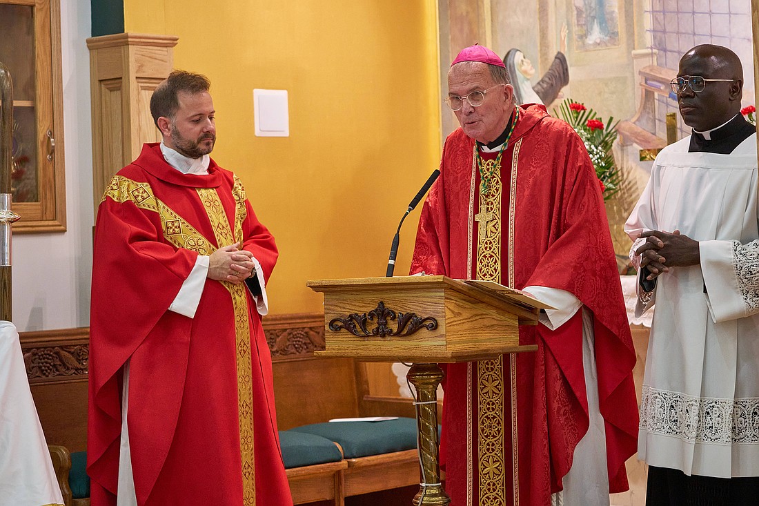 At the start of Mass, Bishop O'Connell greeted the congregation and introduced Father Osborn as their new parish. Vic Mistretta photo