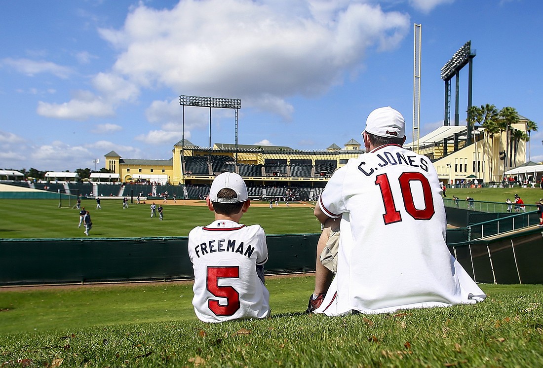 A son who sits next to his father while watching the baseball game in Lake Buena Vista, Fla., March 4, 2019. (OSV News photo/Butch Dill-USA TODAY Sports via Reuters)