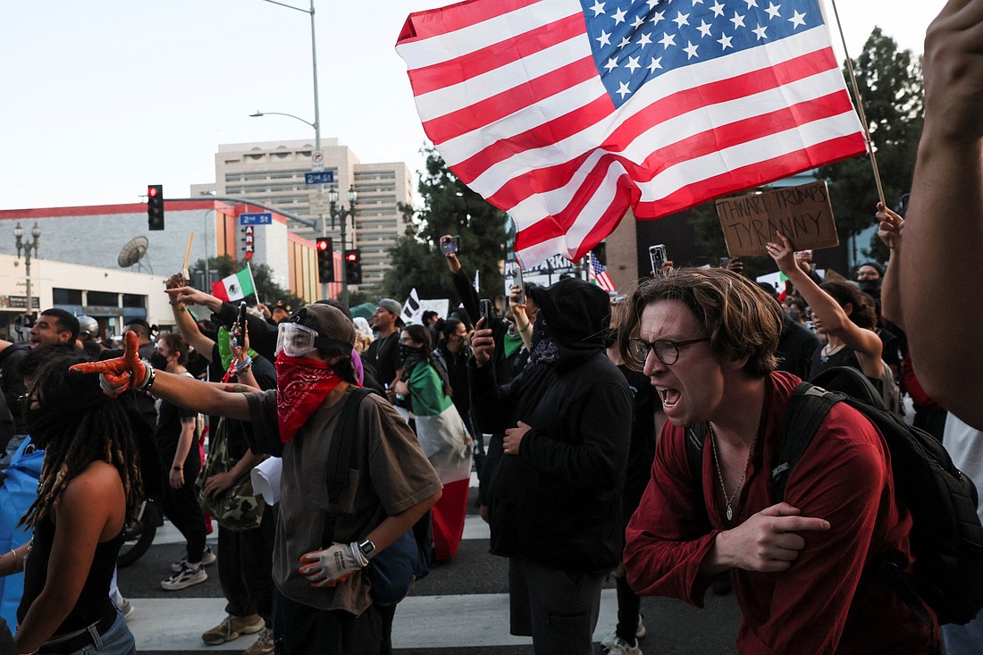 Demonstrators react to crowd control munitions being shot at them by law enforcement in downtown Los Angeles June 10, 2025, as protests against federal immigration sweeps continue. OSV News photo/Leah Millis, Reuters)