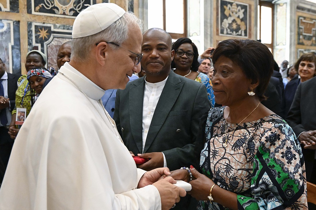 Pope Leo XIV greets Gertrude Kamara Ntawiha, mother of the newly beatified Congolese martyr Blessed Floribert Bwana Chui, during an audience in the Clementine Hall at the Vatican June 16, 2025. Blessed Bwana Chui's brother Tresor looks on. (CNS photo/Vatican Media)