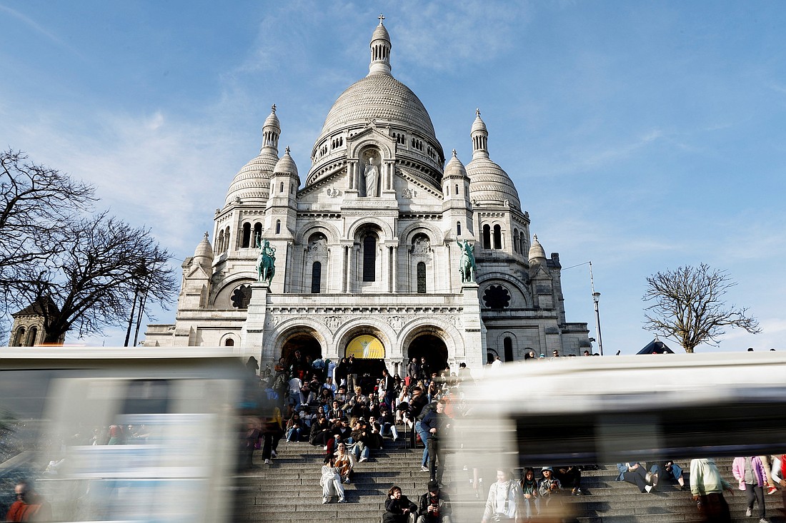 People gather outside Sacre-Coeur, or the Basilica of the Sacred Heart, at the Butte Montmartre in Paris March 19, 2025. The famed basilica, called a "stone host placed on the open wound of the city," celebrated the 150th anniversary of the laying of its first stone June 15, 2025. (OSV News photo/Abdul Saboor, Reuters)