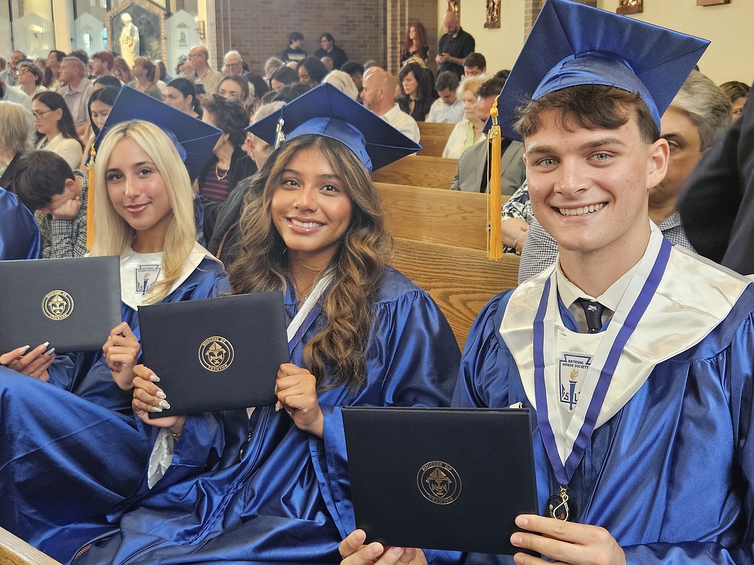 Donovan Catholic graduates, from left, Sofia Gaspari, Jayden Gialanella and James Gibbons proudly show their diplomas following the commencement exercises June 2 in St. Joseph Church, Toms River. Mary Stadnyk photo