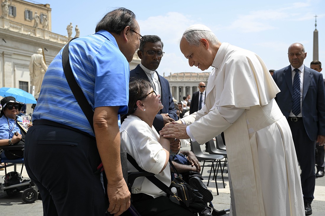Pope Leo XIV blesses a woman in St. Peter's Square after his general audience at the Vatican June 18, 2025. (CNS photo/Vatican Media)