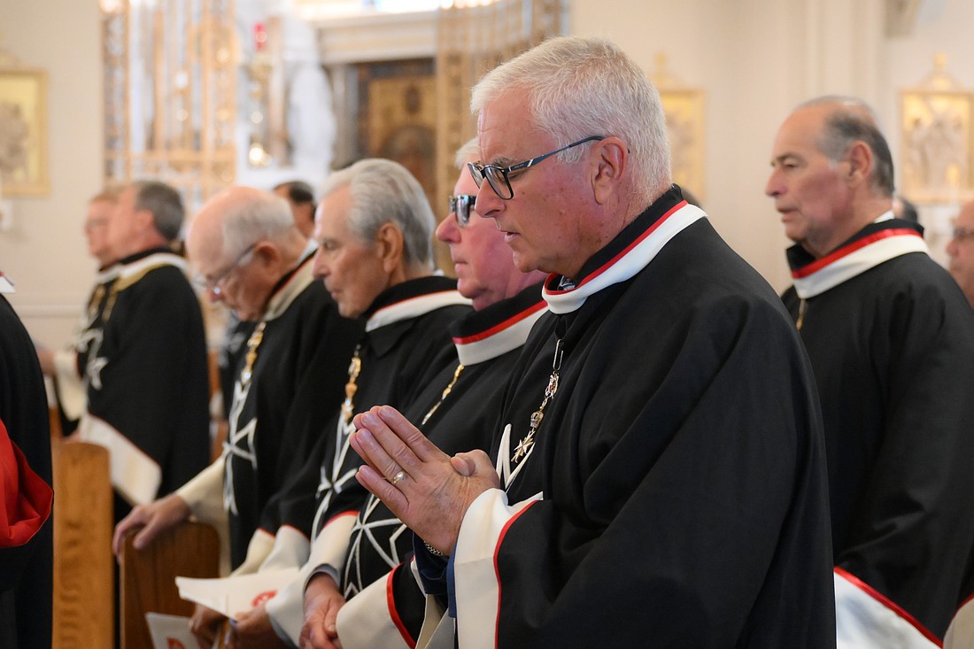 Order of Malta members pray during the Mass. Mike Ehrmann photos