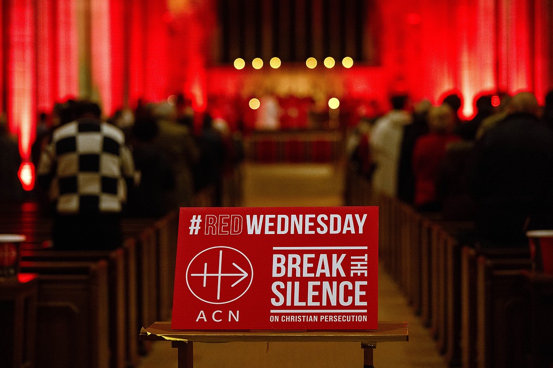 A sign is displayed during a Mass to mark the annual Aid to the Church in Need "Red Wednesday" commemoration for persecuted Christians in St. George’s Cathedral, Southwark, London on Nov. 22, 2023. (OSV News photo/courtesy ACN)