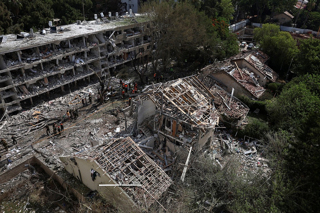 Emergency personnel work at an impact site following a missile attack from Iran on Israel, amid the Iran-Israel conflict, in Tel Aviv, Israel, June 22, 2025. (OSV News photo/Violeta Santos Moura, Reuters) ..TPX IMAGES OF THE DAY