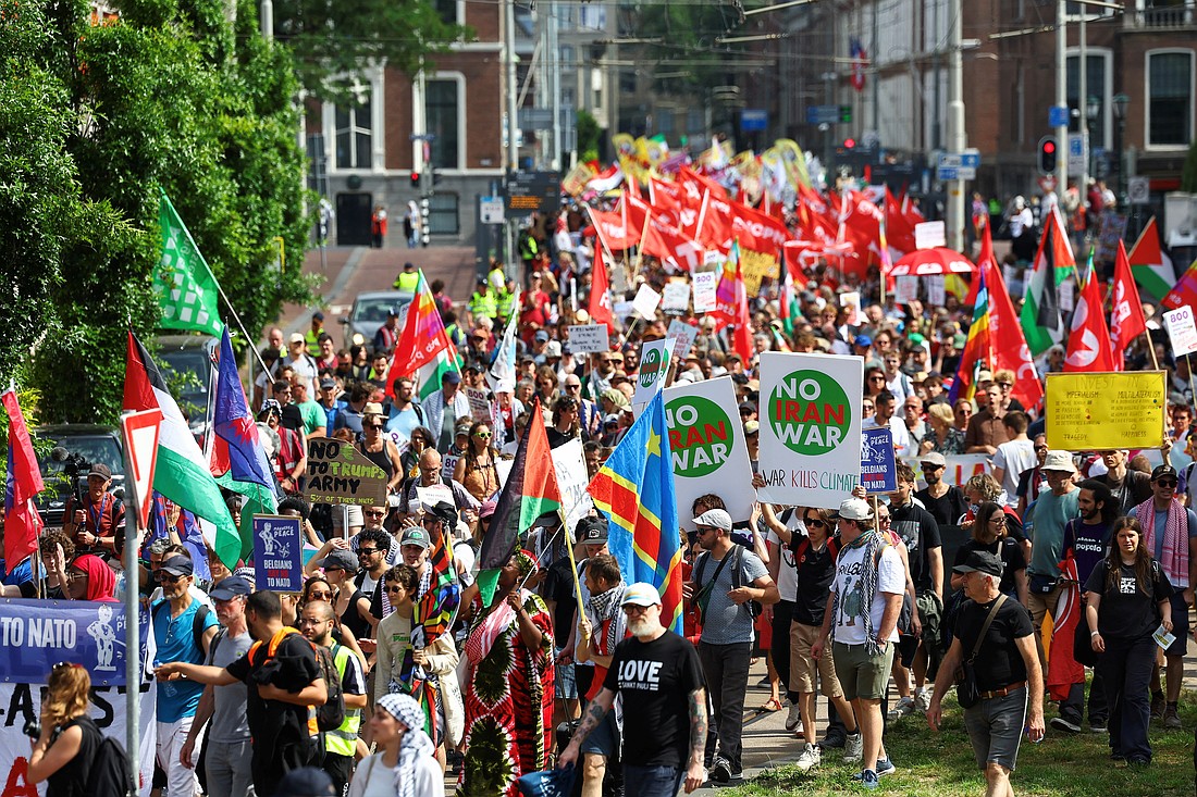 Demonstrators hold signs against a war in Iran, during a march against the upcoming NATO leaders' summit, at The Hague, Netherlands, June 22, 2025. (OSV News photo/Piroschka van de Wouw, Reuters)