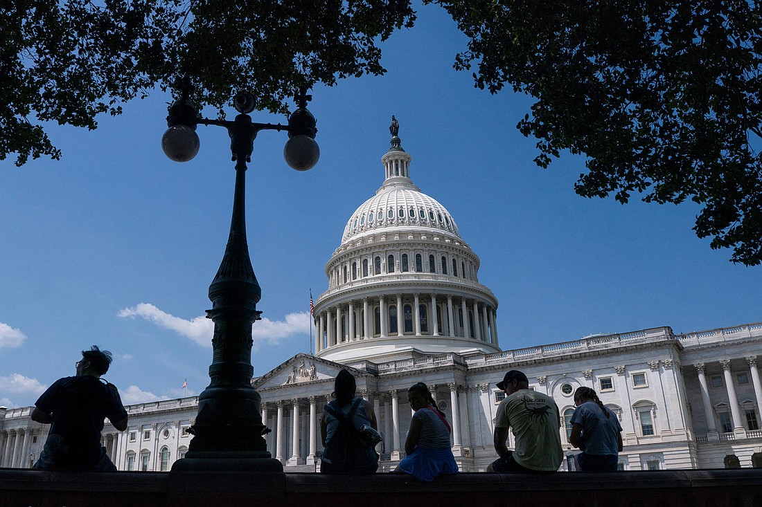 Visitors to the U.S. Capitol rest in the shade on Capitol Hill in Washington June 25, 2025. (OSV News photo/Nathan Howard, Reuters)