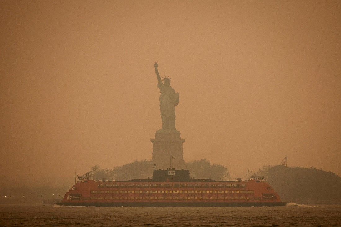 The Statue of Liberty is covered in haze and smoke caused by wildfires in Canada, in New York June 6, 2023. Catholic advocates are concerned about provisions in the 2025 budget bill on Capitol Hill that would defund America's clean energy investments and pollution reduction programs. (OSV News photo/Amr Alfiky, Reuters)