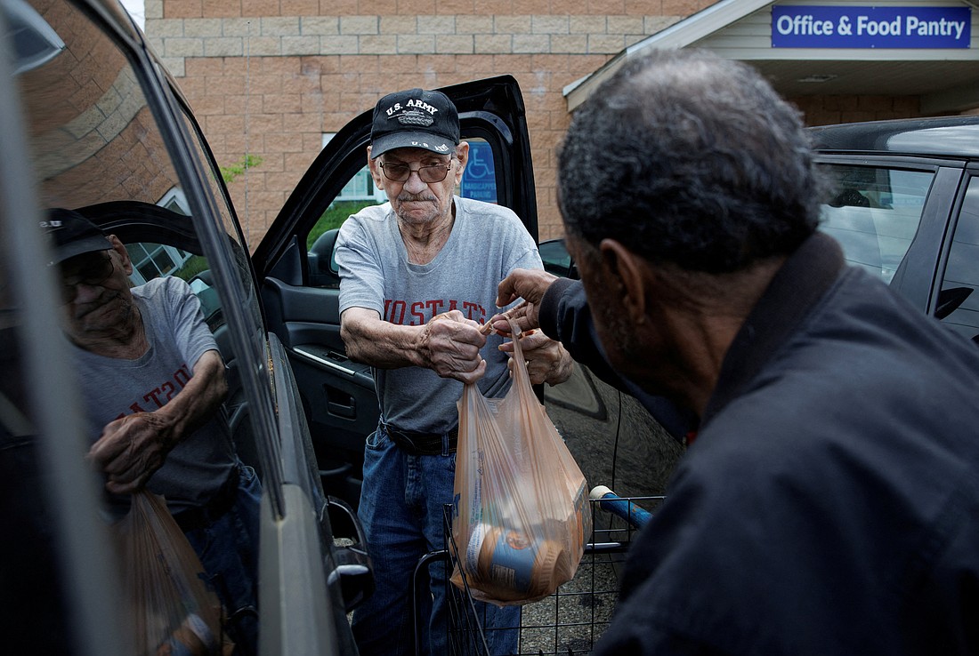 Volunteer Walter Rogers, 83, helps Merrill Hancock, 87, load the groceries he received May 12, 2025, from the Eastside Community Ministry pantry in Zanesville, Ohio. The pantry is supplied by the Mid-Ohio Food Collective, a food bank that has long been part of the backbone of the nation's anti-hunger system, channeling government support into meals. (OSV News photo/Evelyn Hockstein, Reuters)