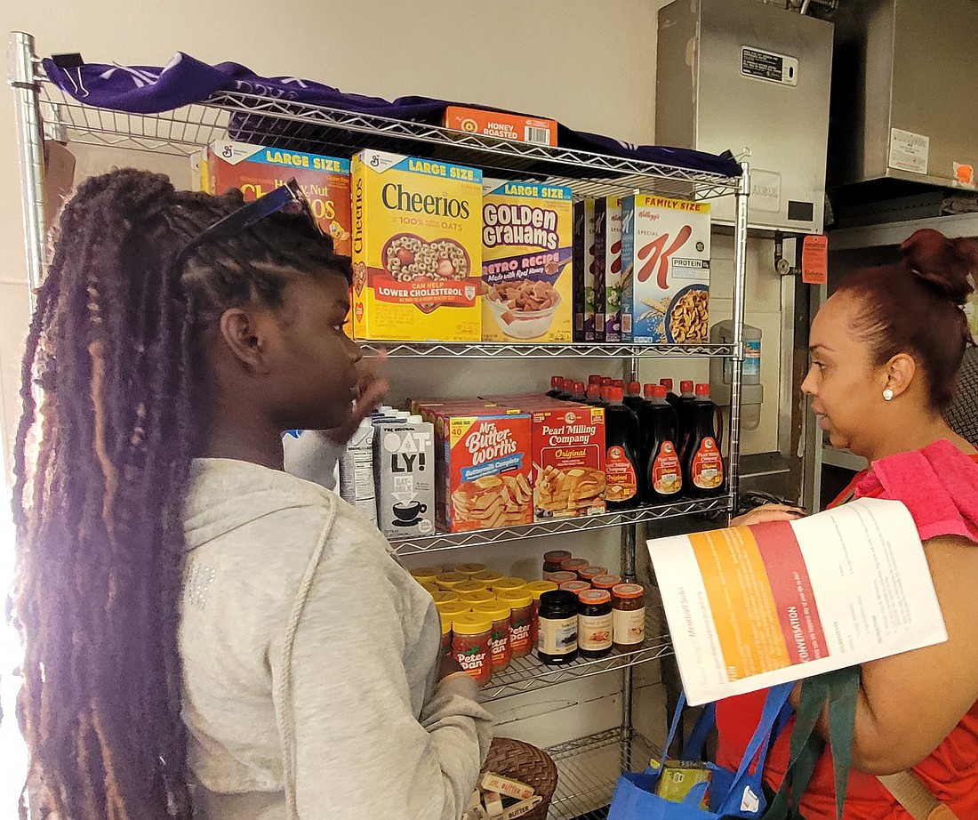 A Mount Carmel Guild volunteer assists a client with selecting food choices. The Guild was one of three agencies in the Diocese to be awarded a grant from the 2025 Bishop Ahr Endowment Fund. Monitor file photo