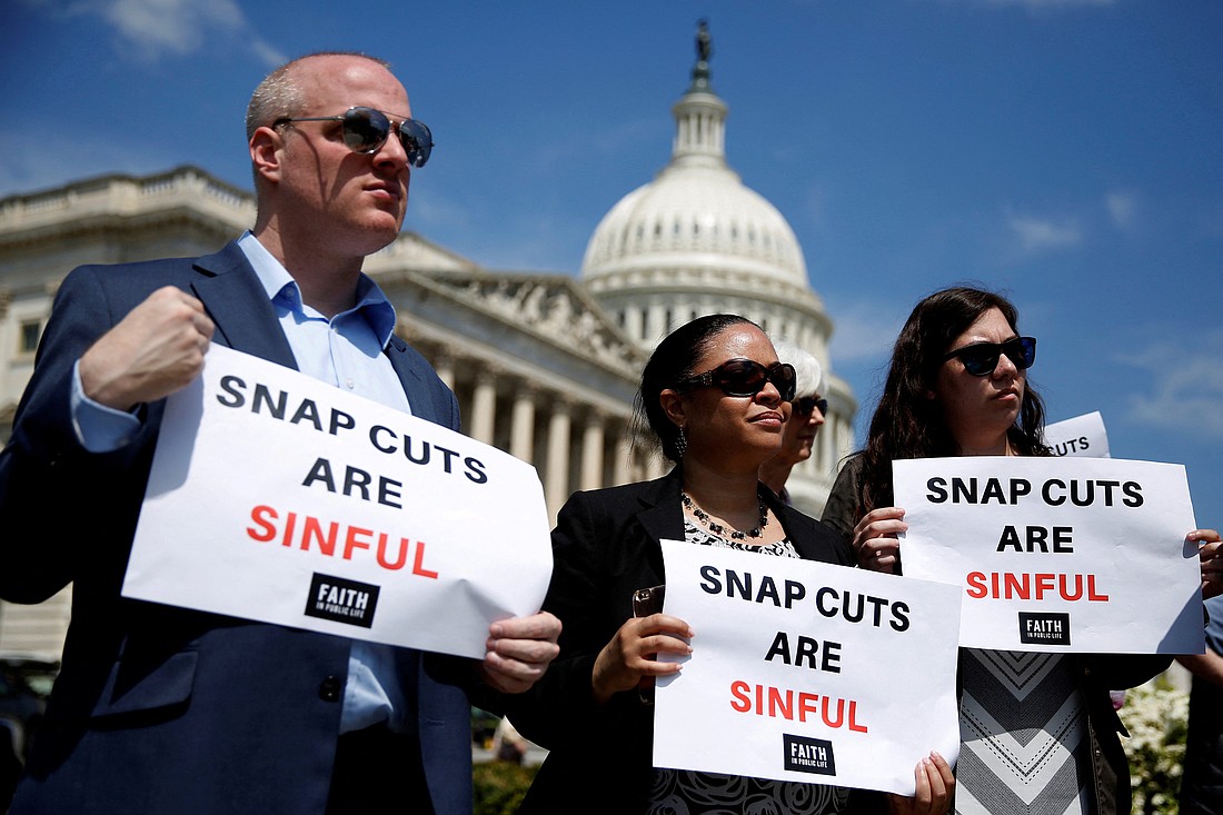 People hold up signs protesting against cuts to the Supplemental Nutrition Assistance Program (SNAP) during a press conference on Capitol Hill in Washington in this file photo. OSV News photo/Joshua Roberts, Reuters