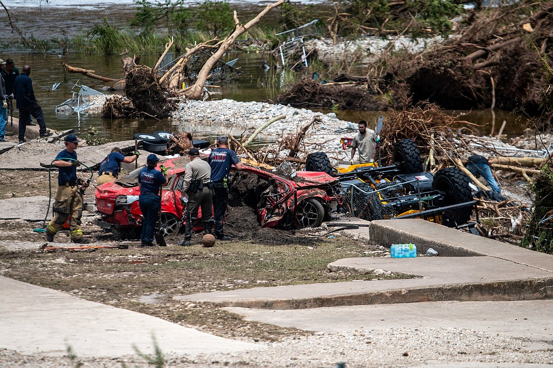 First responders attend to a vehicle pulled from the water in the aftermath of deadly flooding in Kerrville, Texas, July 6, 2025. At least 82 people are dead and at least 41 more are missing after devastating flash floods slammed the Texas Hill Country, with water rescues taking place along the Guadalupe River, which rose rapidly early July 4 to the height of a two-story building. Among the missing were almost a dozen from Camp Mystic in Kerr County, a children's summer camp, officials said July 6. (OSV News photo/Sergio Flores, Reuters)