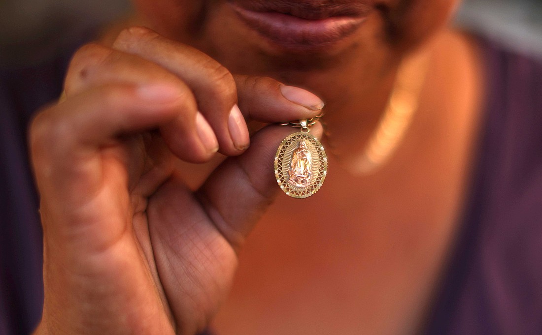 A Guatemalan woman shows her Our Lady of Guadalupe medal in Los Angeles, June 16, 2025, that she has been keeping since the immigration sweeps began. In the neighboring Diocese of San Bernardino, Calif., Bishop Alberto Rojas on July 8 dispensed the faithful in his diocese from the obligation to attend Sunday Mass if they fear for their well-being amid raids by U.S. Immigration and Customs Enforcement. (OSV News photo/Pilar Olivares, Reuters)