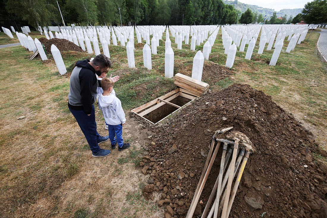 Aljo Mujcic, a Bosnian man, shows his sons a spot dug ahead of a mass funeral marking the 30th anniversary of the Srebrenica genocide, at the Srebrenica-Potocari Memorial Center in Potocari, near Srebrenica, Bosnia-Herzegovina, July 9, 2025. July 11 is the International Day of Reflection and Commemoration of the 1995 Genocide in Srebrenica. (OSV News photo/Amel Emric, Reuters)