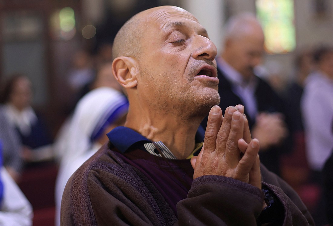 A Palestinian Christian prays during Mass at Holy Family Church in Gaza City, after the death of Pope Francis was announced by the Vatican, April 21, 2025. Father Gabriel Romanelli, pastor of Holy Family Church, admitted his flock is exhausted by war and a severe lack of food. The priest spoke to Vatican Radio amid tragedy after tragedy unfolding in the enclave, with at least 32 people killed by Israeli strikes only on July 13, including six children at a water collection point. (OSV News photo/Dawoud Abu Alkas, Reuters)