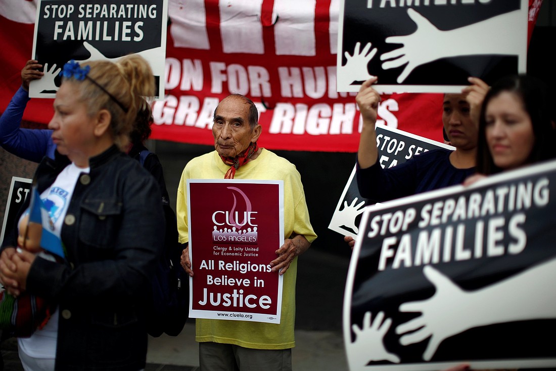 A file photo shows people holding signs at a protest in Los Angeles against plans to deport Central American asylum seekers. (OSV News photo/Lucy Nicholson, Reuters)