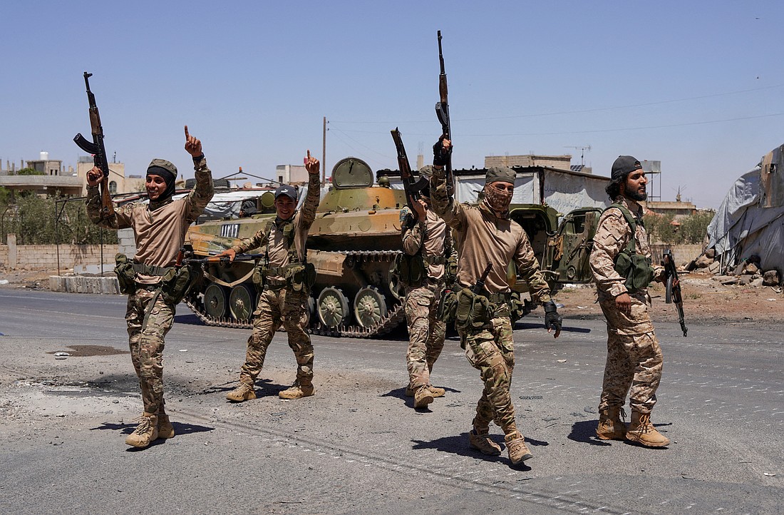 Syrian security forces walk together along a street, after clashes between Syrian government troops and local Druze fighters resumed in the southern Druze city of Sweida, Syria, early on July 16, 2025, collapsing a ceasefire announced just hours earlier that aimed to put an end to days of deadly sectarian bloodshed. As alarming sectarian violence swept through Syria in the third week of July, Christian communities in the region experienced a new wave of persecution. (OSV News photo/Karam al-Masri, Reuters)