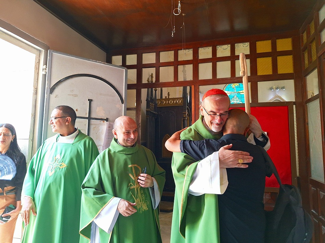 Latin Patriarch of Jerusalem Cardinal Pierbattista Pizzaballa greets parishioners in the Holy Family Parish in Gaza City July 20, 2025. He entered the Gaza Strip July 18 together with Greek Orthodox Patriarch of Jerusalem Theophilos III, offering his support, closeness and prayers following the Israeli army's July 17 attack on the parish. He is accompanied by Father Gabriel Romanelli, the parish priest who was injured during the attack, which killed three Christians sheltering in the parish. (OSV News/courtesy Holy Family Parish)