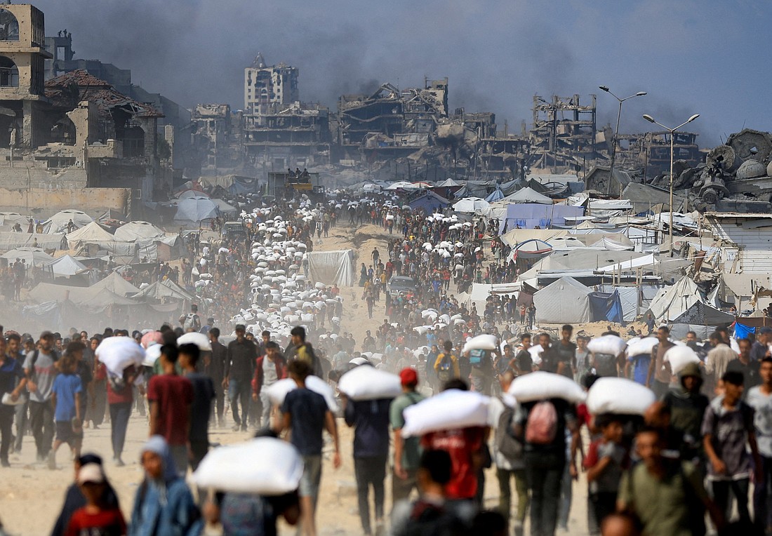 Palestinians gather as they carry aid supplies that entered Gaza through Israel, amid a hunger crisis, in Beit Lahia in the northern Gaza Strip July 20, 2025. (OSV News photo/Dawoud Abu Alkas, Reuters)