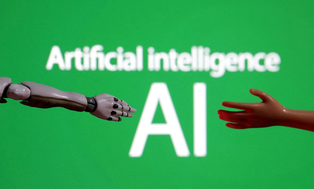 The words "Artificial intelligence AI" are pictured with a miniature of a robot arm and a toy hand are in this Dec. 14, 2023, illustration. (OSV News photo/Dado Ruvic, Reuters)