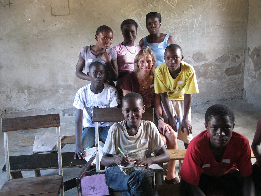 Maryjane Gallo stands with school children she helped serve in Tanzania, Africa, during her 2011 sabbatical with the Catholic Medical Mission Board.