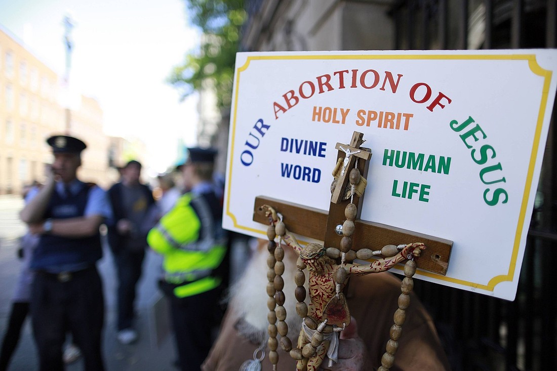 A file photo shows a sign with a crucifix and rosary during a pro-life demonstration outside the Irish Parliament in Dublin. Statistics released by the Department of Health in Ireland showed that abortions in Ireland spiked in the space of just five years.  (OSV News photo/Cathal McNaughton, Reuters)