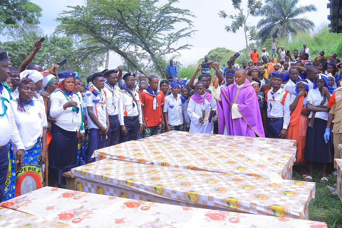 Father Aime Lokana Dhego sprinkles holy water on caskets during a funeral Mass in Komanda, in Congo's province of Ituri, July 28, 2025, for victims of a horrific attack on the Catholic church in Komanda, where at least 43 faithful were shot or killed with machetes during an overnight vigil in the church July 27. (OSV News photo/courtesy Father Justin Zanamuzi) EDITORS:best quality available.