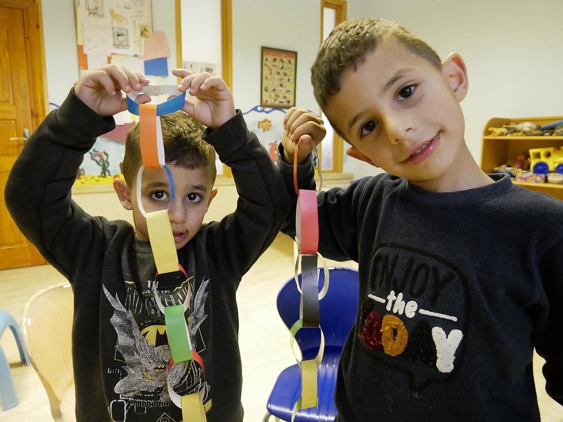 Palestinian boys in this undated photograph look on as they prepare Christmas decorations at the orphanage run by the Sisters of St. Elizabeth in Bethlehem, West Bank. Amid the Israel-Hamas war in the nearby Gaza Strip, this Catholic-run orphanage offers a refuge of love and stability. (OSV News/courtesy Sister Szczepana Hrehorowicz)