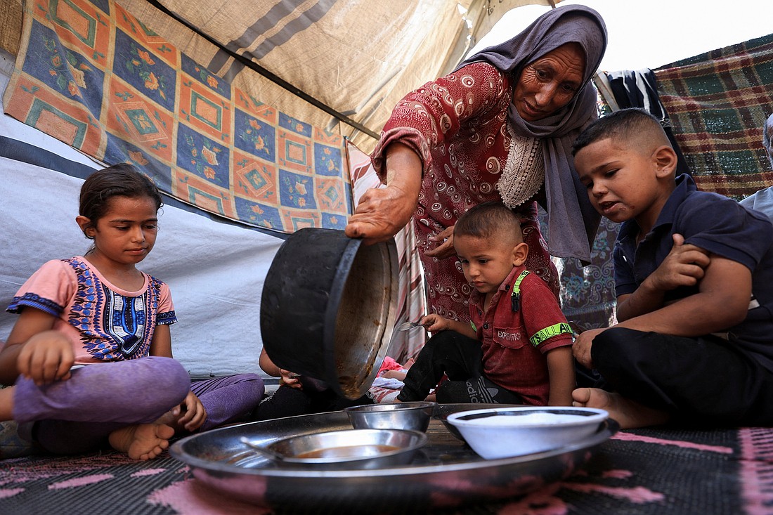Nemah Hamouda prepares food for her grandchildren in Gaza City July 29, 2025, using limited ingredients amid a critical shortage of infant formula and widespread malnutrition. A United Nations-affiliated organization that tracks food security worldwide has issued a dire alert confirming that a "worst-case" famine scenario is unfolding across the Gaza Strip. (OSV News photo/Dawoud Abu Alkas, Reuters)