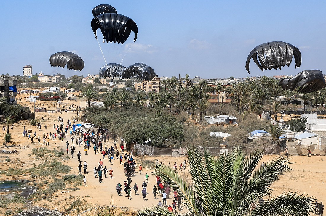 Aid packages dropped from an airplane descend over Gaza, as seen from the central Gaza Strip July 31, 2025. Jennifer Poidatz, acting representative for Catholic Relief Services in Jerusalem, the West Bank and Gaza, told OSV News July 31 that Gaza-based CRS staff are working to bring high-calorie, high-protein food to residents amid destroyed agricultural lands, fuel and energy deficits, high prices, danger and disease. (OSV News photo/Hatem Khaled, Reuters)