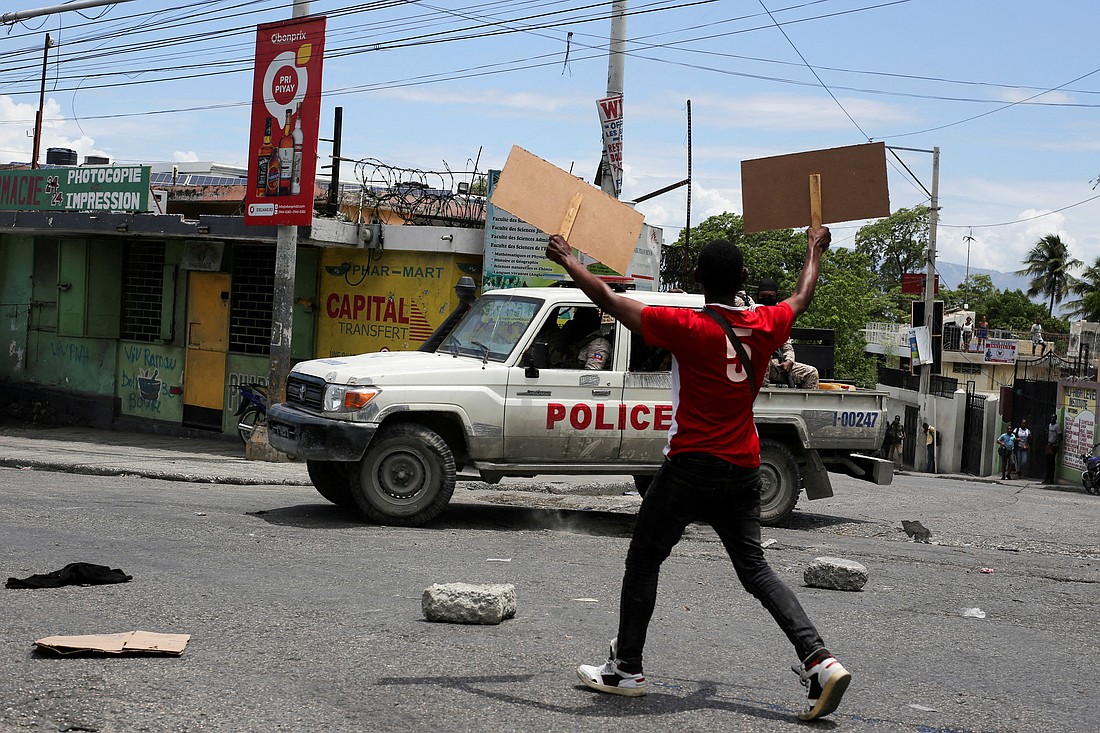 A man holds up placards as he yells toward a patrol car during a protest against gang-related violence in Port-au-Prince, Haiti, May 15, 2025, in this file photo. (OSV News photo/Jean Feguens Regala, Reuters)