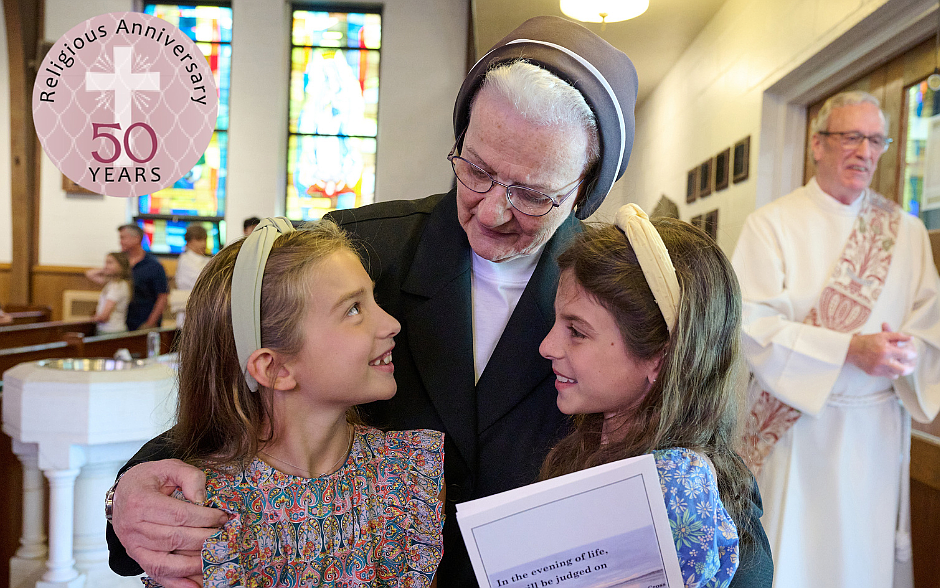 Sister Elizabeth Seton Dalessio engages in conversation with two St. Jerome School students following the Mass of Thanksgiving celebrated in May marking her golden jubilee. Mike Ehrmann photo