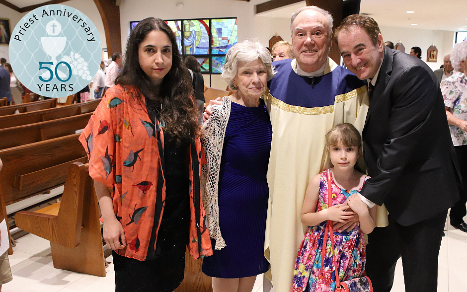 Father Roberts’ family members join him for a photo; from left, his nephew’s wife Dana Roberts, his sister-in-law Andrea Roberts, his great niece River Roberts, and his nephew David Roberts. John Batkowski photo
