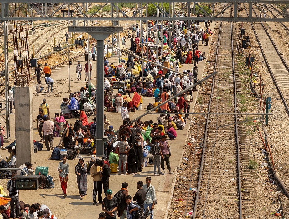 People sit on a platform as they wait to board a train at a railway station in Jammu, India, May 10, 2025. Two Catholic nuns and an Indigenous youth who were arrested on July 25 at Durg railway station in Chhattisgarh state were granted bail and released Aug. 2 under strict conditions. They were arrested for alleged human trafficking and forced conversion in central India. (OSV News photo/Adnan Abidi, Reuters)